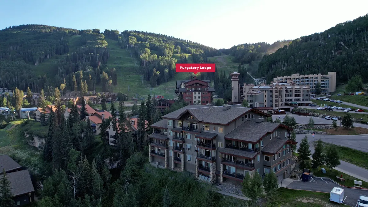 Another sweeping exterior shot highlighting Purgatory Lodge with the surrounding mountains and nearby lodges visible. The scene suggests opportunities for skiing, hiking, and other outdoor adventures in a serene natural setting.